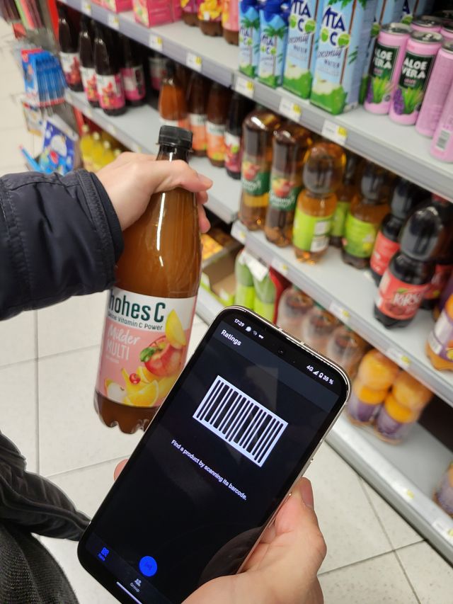 Photo of a person scanning a product on the supermarket shelf